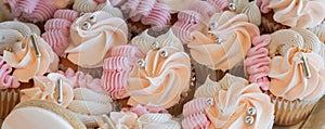 Cupcakes with silver sugar pearls, vanilla cupcakes with pink, white and peach cream