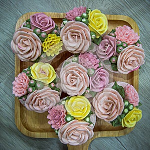 Cupcakes topped with rose shaped cream