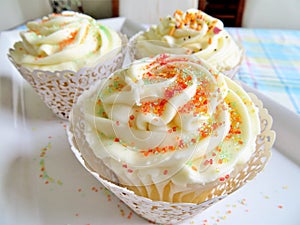 Cupcakes with vanilla frosting and sprinkles