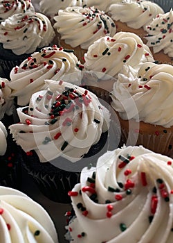 Cupcakes with white icing and red and blue sprinkles