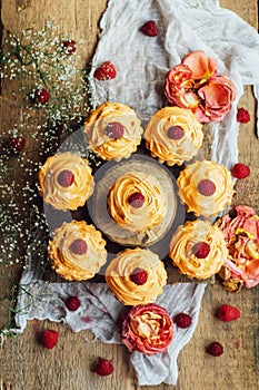 Cupcakes on wooden table. Homemade decorated muffins on the tab