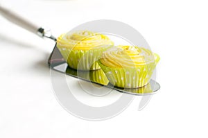 Cupcakes with yellow cream on cake shovel
