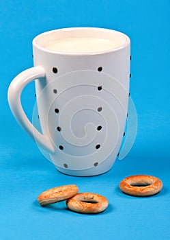 Cupful of milk and bread rings photo