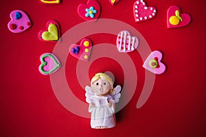 Cupid doll and heart-shaped on red background