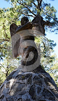 cupid rock sculpture in the woods photo