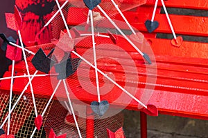 Cupid's arrows on a red wooden bench. Background with selective focus and copy space