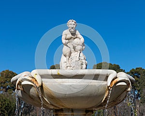 Cupid statue in the fountain of the Garden of Roses in Buen Retiro Park. Madrid