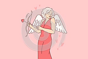 Cupid woman dressed up with wings for valentine day, uses with arrow and bow to seduce boyfriend photo