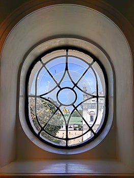 Cupola of monastery seen through the vintage window