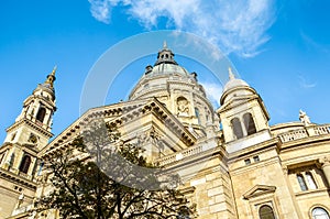 Cupola and tower of Saint Stephen`s Basilica in Budapest, Hungary with blue sky above. Historical sample of neoclassical