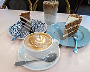 Cuppacino coffee with cakes on the table for tea time