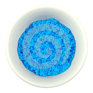 Cupric sulfate in porcelain bowl over white photo