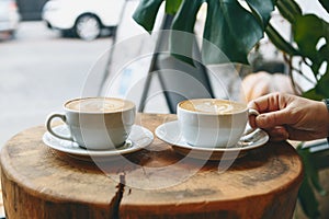 Cups of aromatic coffee cappuccino photo