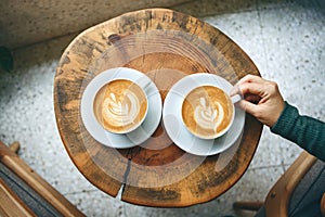 Cups of aromatic coffee cappuccino photo