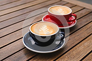Cups of aromatic coffee on wooden table