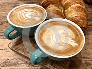 Cups of coffee and croissants
