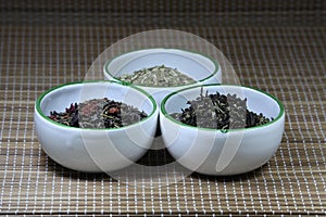 Cups containing herbs on a mat