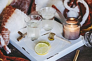 Cups of lemon and cinnamon tea in a cozy atmosphere at home