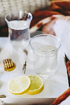 Cups of lemon and cinnamon tea in a cozy atmosphere at home