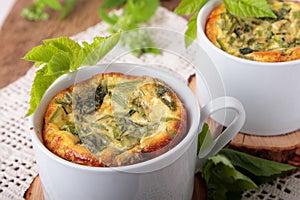 Cups of omelette with goutweed