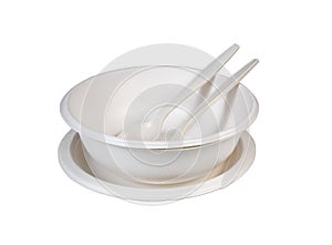 Cups and plates of paper and plastic spoons and fork on white