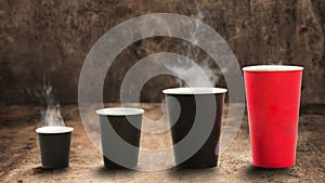 Cups with sorts of coffee evaporating smoke