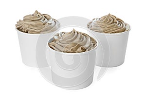 Cups with tasty frozen yogurt on white
