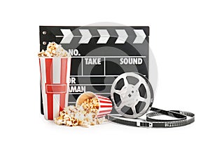 Cups with tasty popcorn, film reel and clapperboard on white background