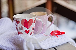 Cups of tea or coffee with steam,heart shape on blurred background. Valentine`s day celebration or love concept. Copy