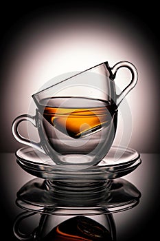 Cups with tea on gray blurred background