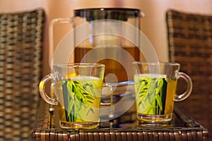 Cups of tea with mint on wooden table in a spa