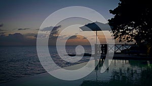 Curacao, couple on vacation in Curacao watching sunset by the pool