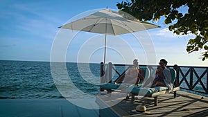 Curacao, couple on vacation in Curacao watching sunset by the pool