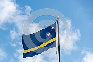 Curacao flag with blue sky in the background