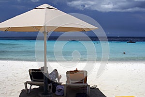 Curacao - relaxing under a beach umbrella