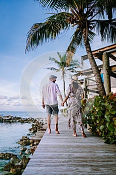 Curacao Willemstad, couple mid age Asian woman and European man on vacation at luxury resort in Pietermaai
