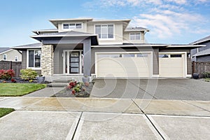 Curb appeal of brand-new home in brown and beige colors