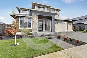 Curb appeal of brand-new home in brown and beige colors photo