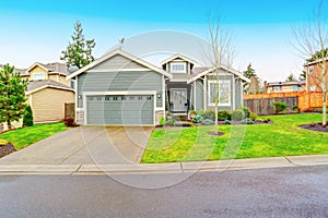 Curb appeal. House exterior with garage and driveway