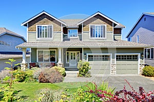 Curb appeal of luxury family house with nice landscape.