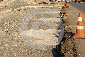 Curb formation and traffic cones at the edge of the carriageway, selective focus