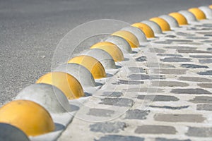 Curb separated asphalt road and cobblestone