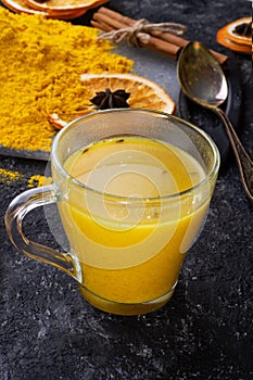 Curcuma turmeric spice , curcuma cocktail served with dry oranges at black table. Food and cuisine ingredients. healthy concept