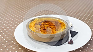 Curd casserole, sprinkled with sugar in a plate, Siurana, Catalunya, Spain. Close-up.