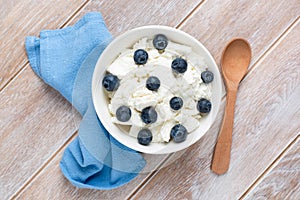 Curd cheese, cottage cheese with blueberries in bowl