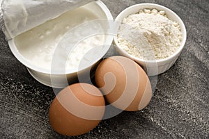 Curd eggs wheat flour on black background