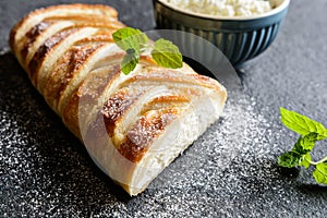 Curd strudel with raisins and sprinkled with icing sugar