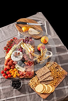 Cured cheese and meze platter rich in variety of fruits, cheese, meat and crackers