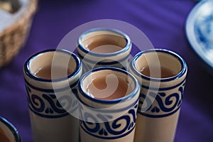 Cured guava mezcals served in a Talavera Puebla tequila caballito, typical Mexican drin photo