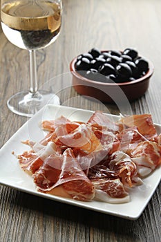 Cured iberian ham and olives tapas photo